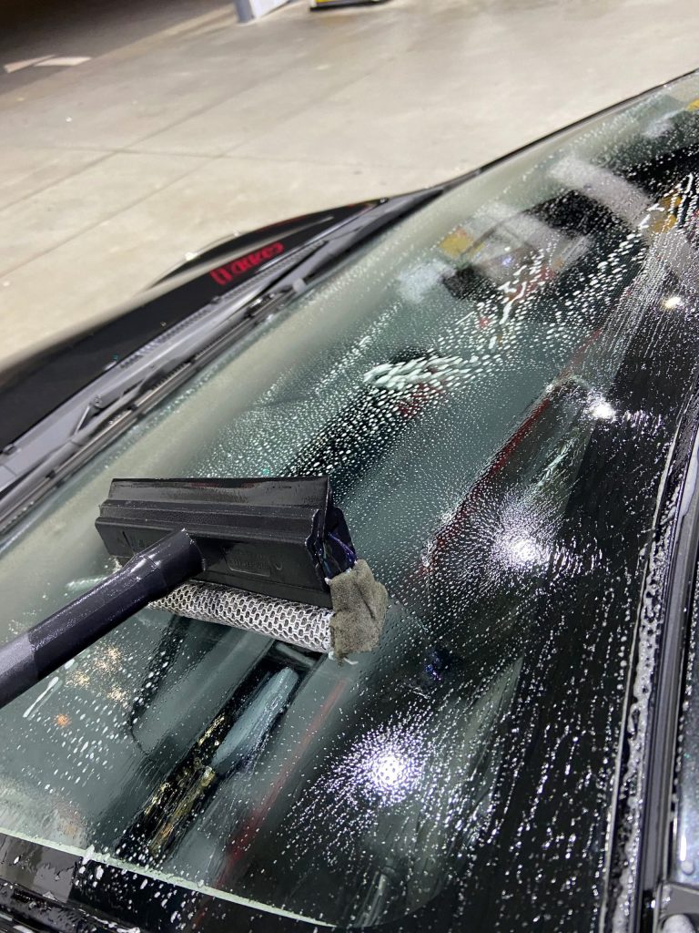 cleaning-window-with-squeegee-soap