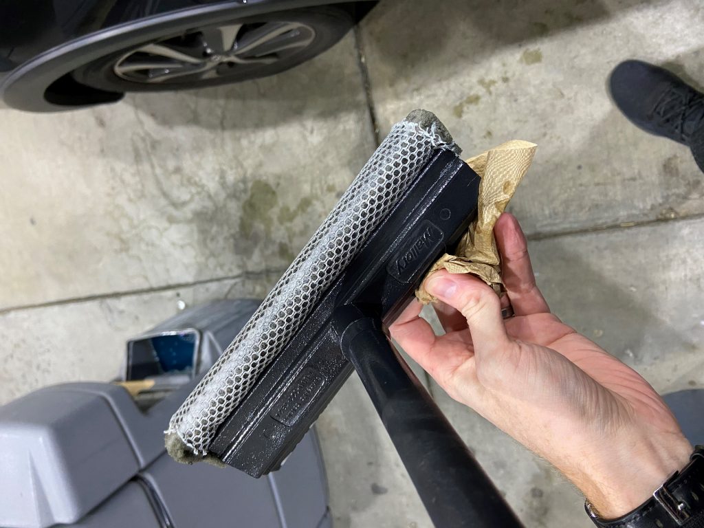 cleaning-window-with-squeegee-towel