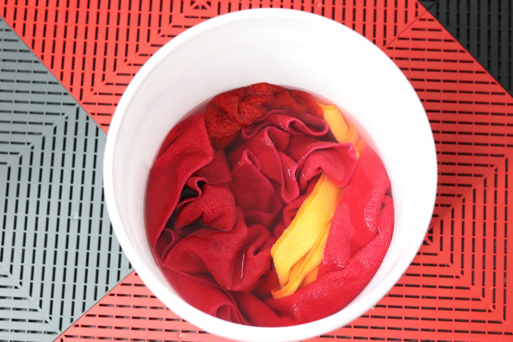 Microfiber towels used for coatings soaking in Rags to Riches prior to washing