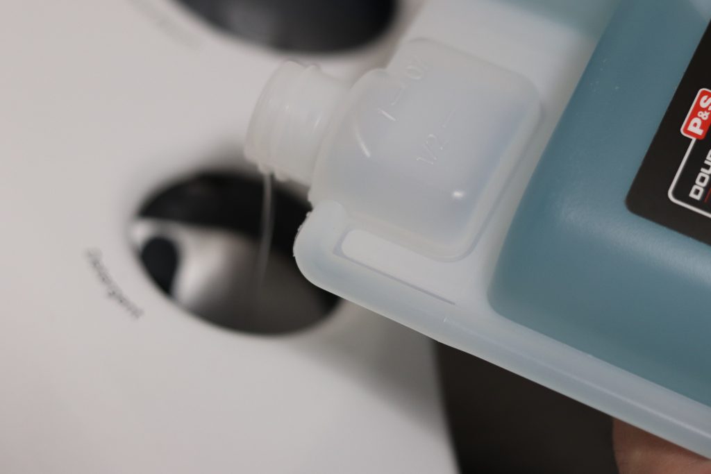Pouring 1 ounce for a small load of microfiber towels