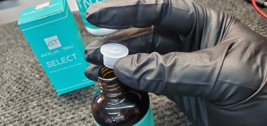 Installing the insert onto the bottle of Aquatek Select prior to using.